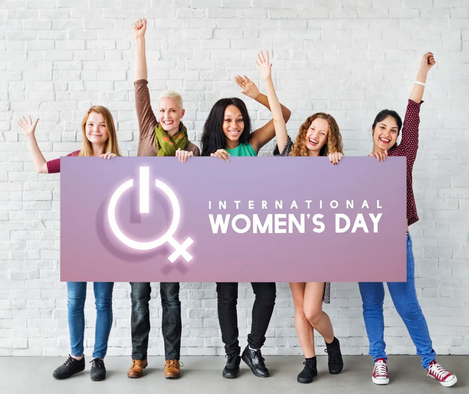 Women behind sign for international women day 2023