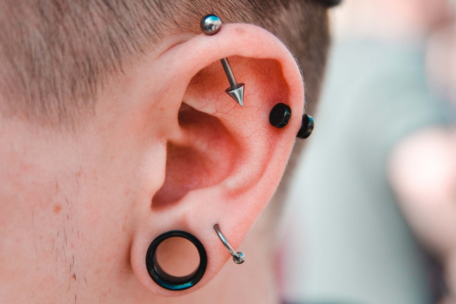 Man with many piercings in ear