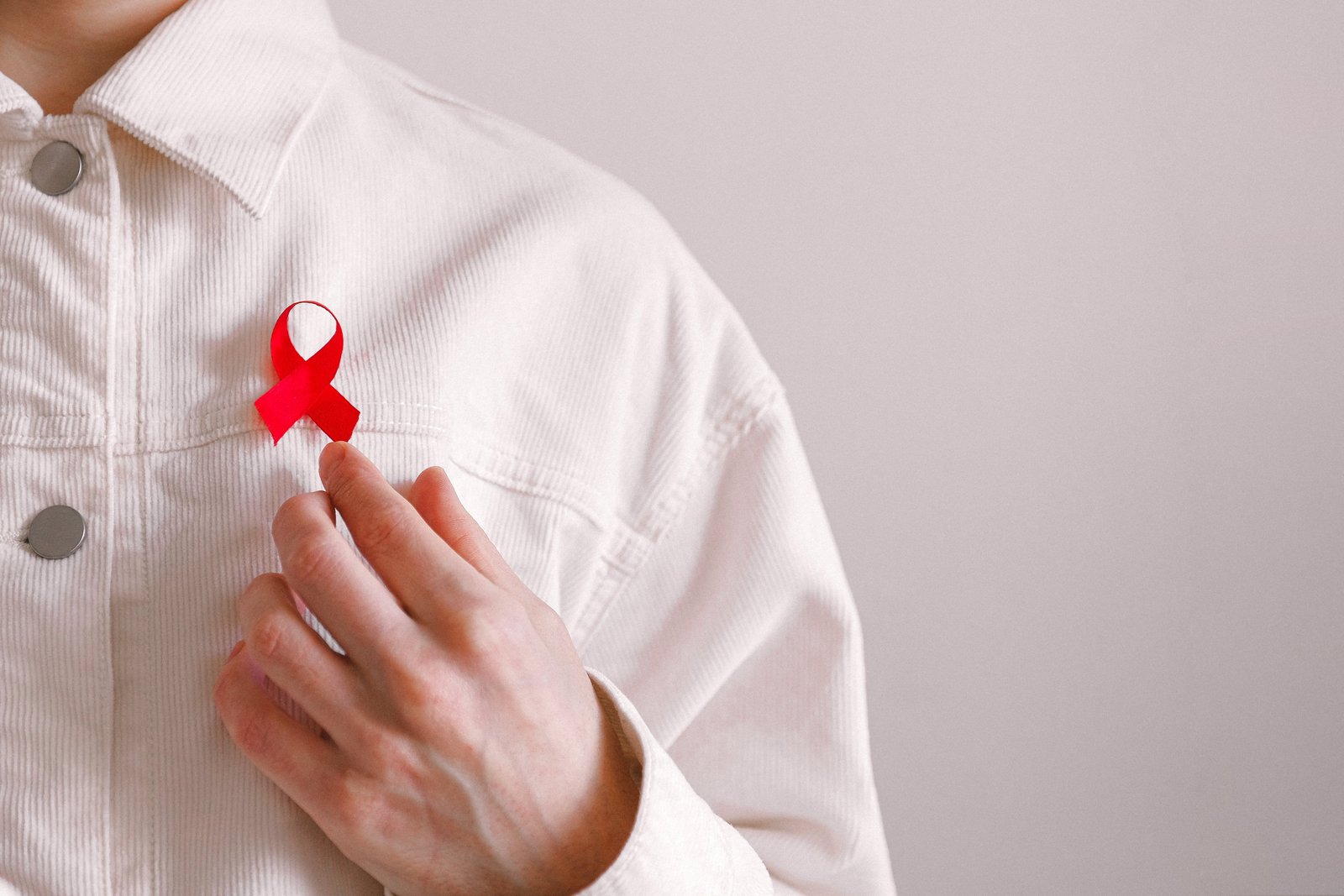 Man with a red ribbon on his shirt on World AIDS Day