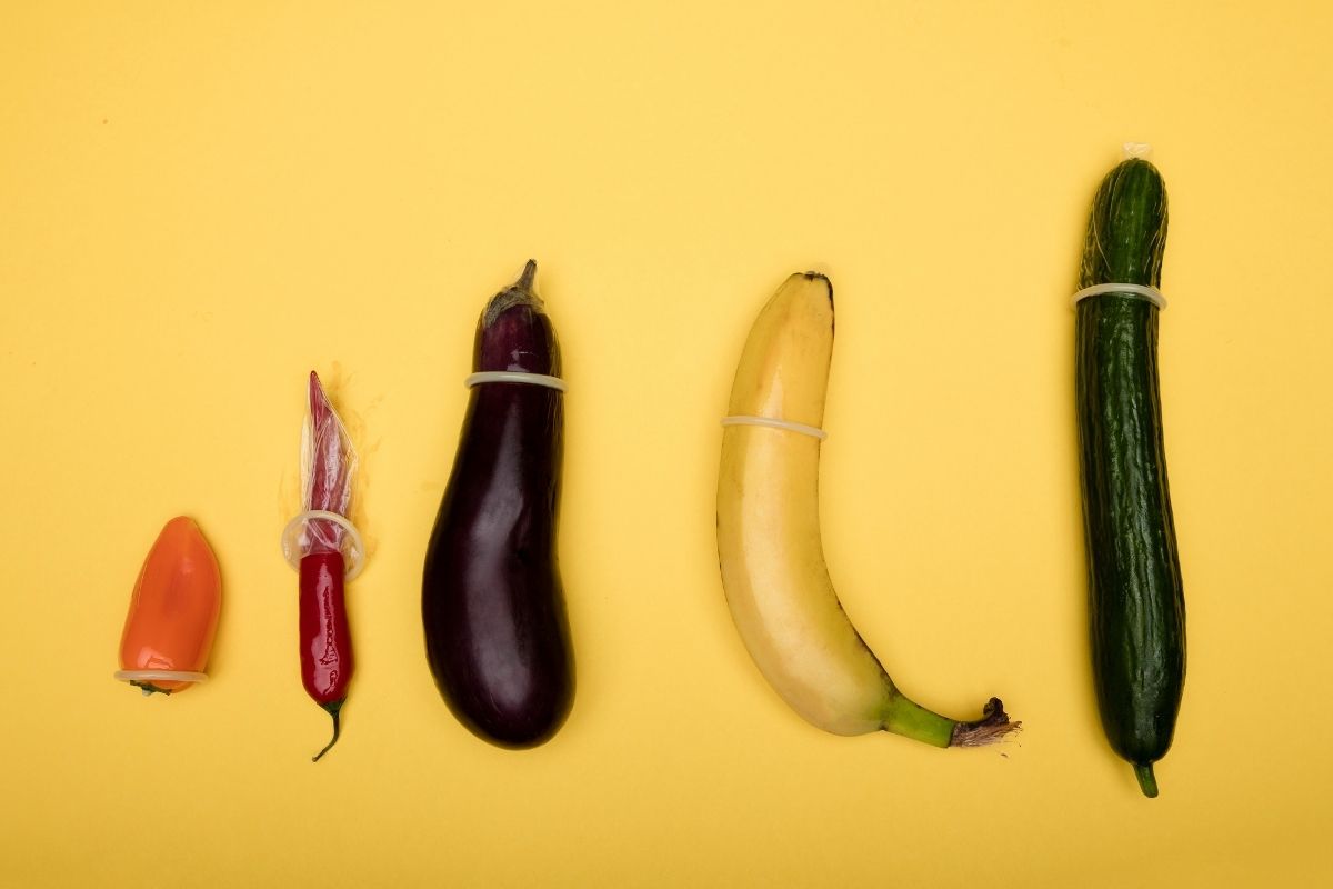Condoms on different size fruits and vegetables